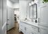 Bathroom with mirror and granite countertop with kitchen in background