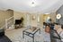 Living area with couches, dining set.