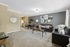 Living area with couches, dining set.