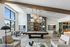 Chic and modern recreation room with a stylish billiards table, cozy seating, and elegant pendant lighting.