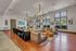 Spacious and contemporary living room with abundant natural light, featuring a plush sectional sofa, modern fixtures, and stylish decor.