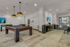 Luxurious entertainment room with a modern pool table, stylish bar area, and ambient lighting for the ultimate leisure experience.