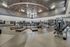 Spacious and modern fitness center featuring state-of-the-art exercise equipment, including treadmills and weight machines, under a stylish ceiling design.