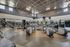 Spacious and modern gym featuring state-of-the-art exercise equipment and an elegant ceiling design.