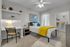 Inviting bedroom with stylish decor, featuring a cozy queen-size bed, modern desk area, and spacious walk-in closet, all bathed in natural light.