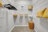 Spacious walk-in closet with elegant shelving, bamboo storage, and decorative yellow pillows for a stylish touch.