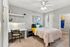 Bright and inviting bedroom with modern decor, featuring a comfortable bed, cozy workspace, and ample natural light.