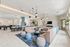 Elegant and spacious common area featuring modern seating, stylish lighting, and a pool table, ideal for social gatherings and relaxation.