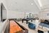 Spacious and inviting recreation room featuring a shuffleboard, pool table, and cozy seating areas with modern decor and abundant natural light.