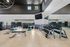 Modern gym with spacious layout, featuring state-of-the-art fitness equipment, sleek mirrored walls, and natural lighting.