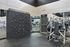 Contemporary fitness center with state-of-the-art equipment and an innovative climbing wall, perfect for a versatile workout experience.