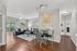 Inviting open-concept living and dining area with elegant decor, hardwood flooring, and ample natural light ideal for comfortable living.
