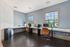 Modern office space with sleek desks, ergonomic chairs, and large windows offering a bright and invigorating environment.