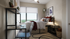 Bright and cozy bedroom with large window, modern desk, and stylish decor.