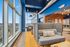 Modern, vibrant common area with large windows offering stunning city views, featuring stylish seating and contemporary decor.