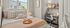 Cozy bedroom with a comfortable plush bed, stylish desk area, and natural light from large windows creating a serene work-from-home retreat.