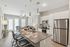 Modern open-concept kitchen and living area featuring sleek cabinetry, stainless steel appliances, and elegant pendant lighting, perfect for entertaining and relaxation.