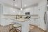 Chic kitchen design with elegant white cabinetry, stylish granite countertops, and modern stainless steel appliances.