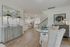 Chic open living space with elegant furnishings, stylish lighting, and a modern kitchen with a breakfast bar.