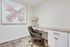 Inviting home office space featuring a chic desk, elegant armchair, and captivating butterfly artwork, perfect for focused productivity.