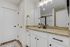 Elegant bathroom with granite countertops, modern fixtures, and ample cabinetry for stylish storage.