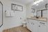 Elegant bathroom with modern fixtures, granite countertop, and stylish art decor, offering a luxurious and inviting ambiance.