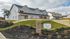 Elegant multi-unit townhouse complex at Preston Park with modern architecture, lush landscaped surroundings, and serene natural views.