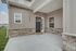 Charming home fa&ccedil;ade with modern stone accents and inviting entryway, perfect for suburban living.