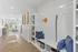 Inviting apartment hallway featuring modern storage solutions, cozy seating, and elegant decor leading to a bright and airy living area.