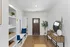 Charming entryway with sleek hardwood floors, stylish storage solutions, and a welcoming front door, exuding warmth and elegance.