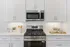 Modern kitchen with sleek stainless-steel appliances, elegant white cabinetry, and stylish decor accents.
