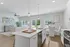 Bright open-concept living space featuring modern kitchen, cozy dining area, and stylish living room with abundant natural light.