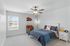 Bright and cozy bedroom with stylish decor, large window for natural light, and a comfortable bed with modern bedding.