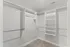 Spacious walk-in closet with sleek shelving and ample hanging space in modern apartment.