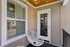 Cozy balcony with modern woven chair and sleek wooden ceiling, perfect for relaxation and enjoying the view.
