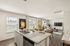 Bright, open-concept living area featuring a modern kitchen island, elegant dining table, and stylish living room with large windows.