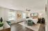 Spacious and elegant bedroom featuring a cozy bed, modern furniture, and large windows with natural light.