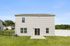 Charming two-story house with modern siding, large windows, and a spacious backyard, perfect for family gatherings.
