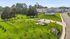 Beautiful residential community with lush green spaces, landscaped gardens, and modern homes set against a serene suburban backdrop.