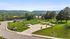 Stunning landscape view showcasing lush greenery, spacious driveways, and charming rural surroundings.