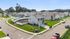 Charming suburban neighborhood with modern two-story homes, lush green lawns, and peaceful streets.