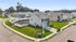 Charming suburban neighborhood featuring modern two-story homes with manicured lawns on a sunny day.