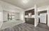 Spacious living room with large windows, natural light, and open layout ideal for relaxing or work from home.