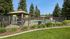 Inviting swimming pool area with shaded seating and lush greenery, perfect for relaxation.