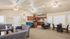 Inviting open-concept apartment featuring a modern kitchen with bar seating, cozy living area, and elegant dining space.