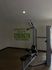 Contemporary gym corner with motivational quote, featuring a sleek exercise machine and inviting natural light.