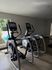 Modern apartment fitness center showcasing state-of-the-art elliptical machines, surrounded by natural light.