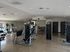 Modern fitness center equipped with state-of-the-art exercise machines and ample space for a dynamic workout.