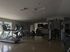 Modern apartment gym with high-end equipment and natural lighting for a top-tier fitness experience.