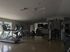 Modern and spacious fitness center featuring state-of-the-art treadmills, exercise machines, and large windows offering natural light.